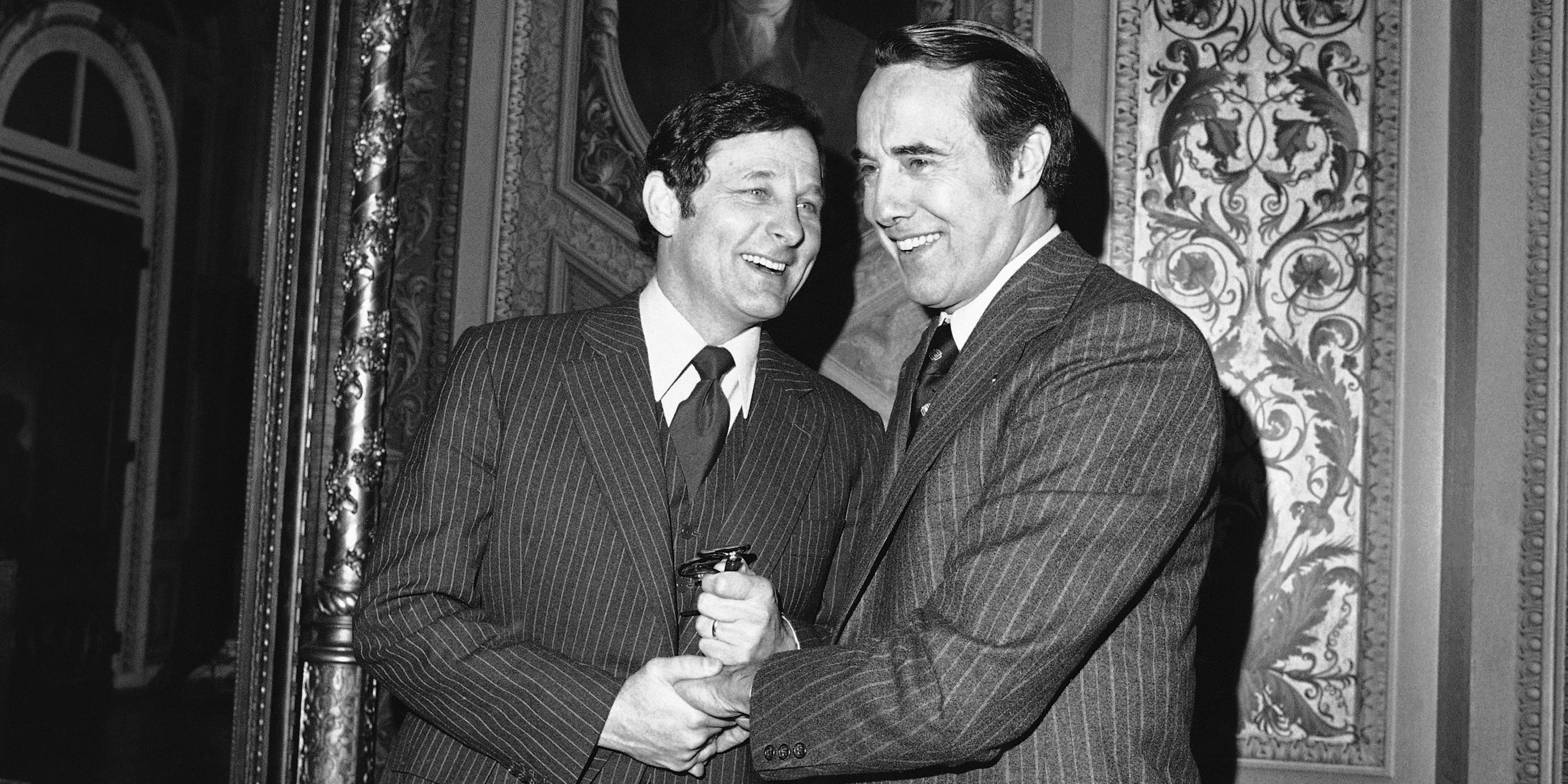 Sen. Birch Bayh, D-Ind., and Sen. Bob Dole, R-Kan., right, get together on Tuesday, Feb. 21, 1978 at the Capitol during a break in a closed session of the Senate that is discussing the Panama Canal treaties. Dole said he would move to make public charges involving Gen. Torrijos and members of his family being involved in drug traffic. Bayh, as chairman of the Senate Intelligence Committee, has custody of classified files dealing with the allegations. (AP Photo/ John Duricka)