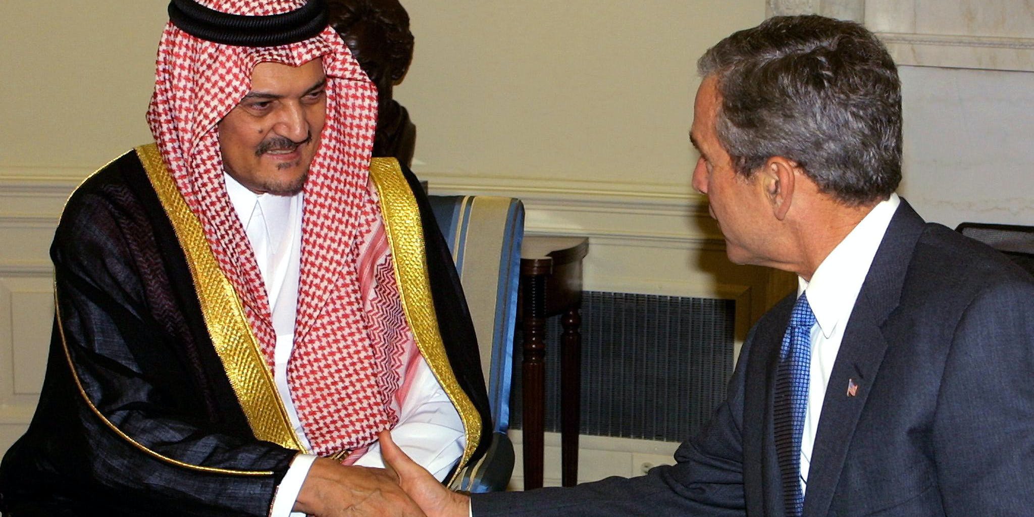 US President George W. Bush (R) meets with Kingdom of Saudi Arabia's Foreign Minister Saud al-Faisal (L) 20 September 2001 in the Oval Office of the White House in Washington, DC.