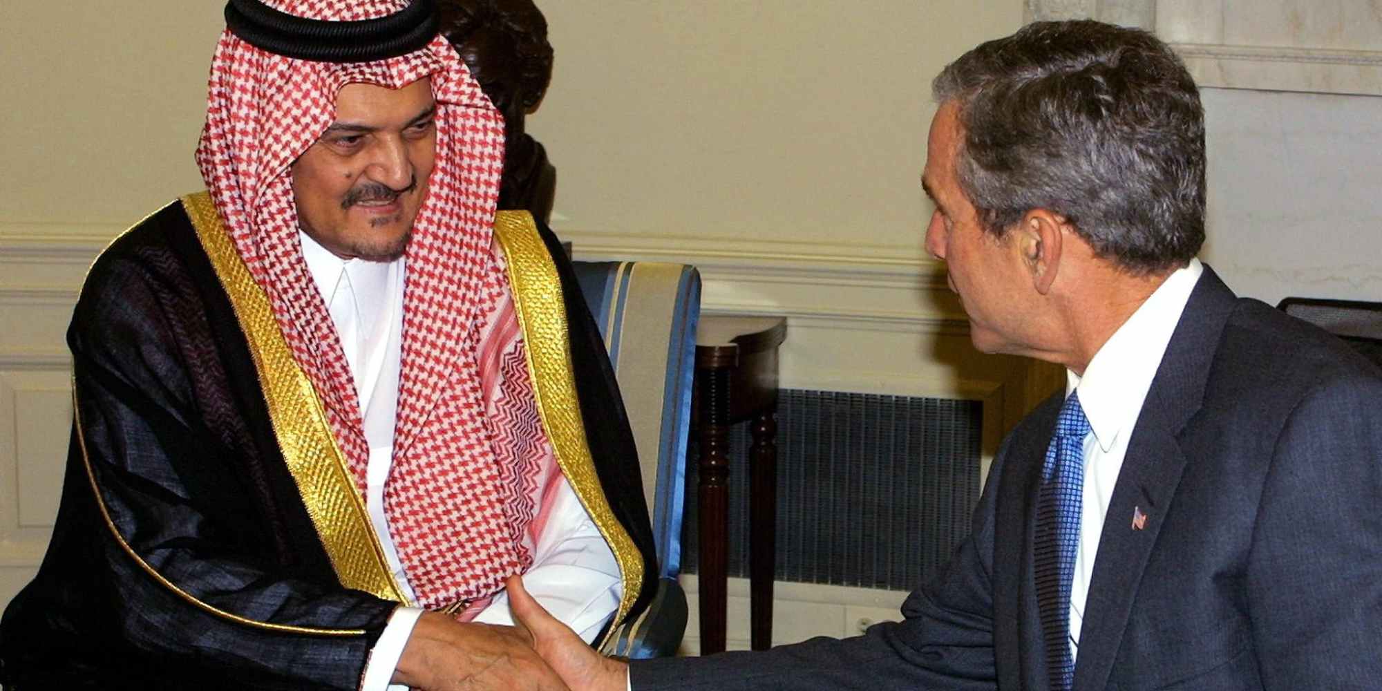 US President George W. Bush (R) meets with Kingdom of Saudi Arabia's Foreign Minister Saud al-Faisal (L) 20 September 2001 in the Oval Office of the White House in Washington, DC.