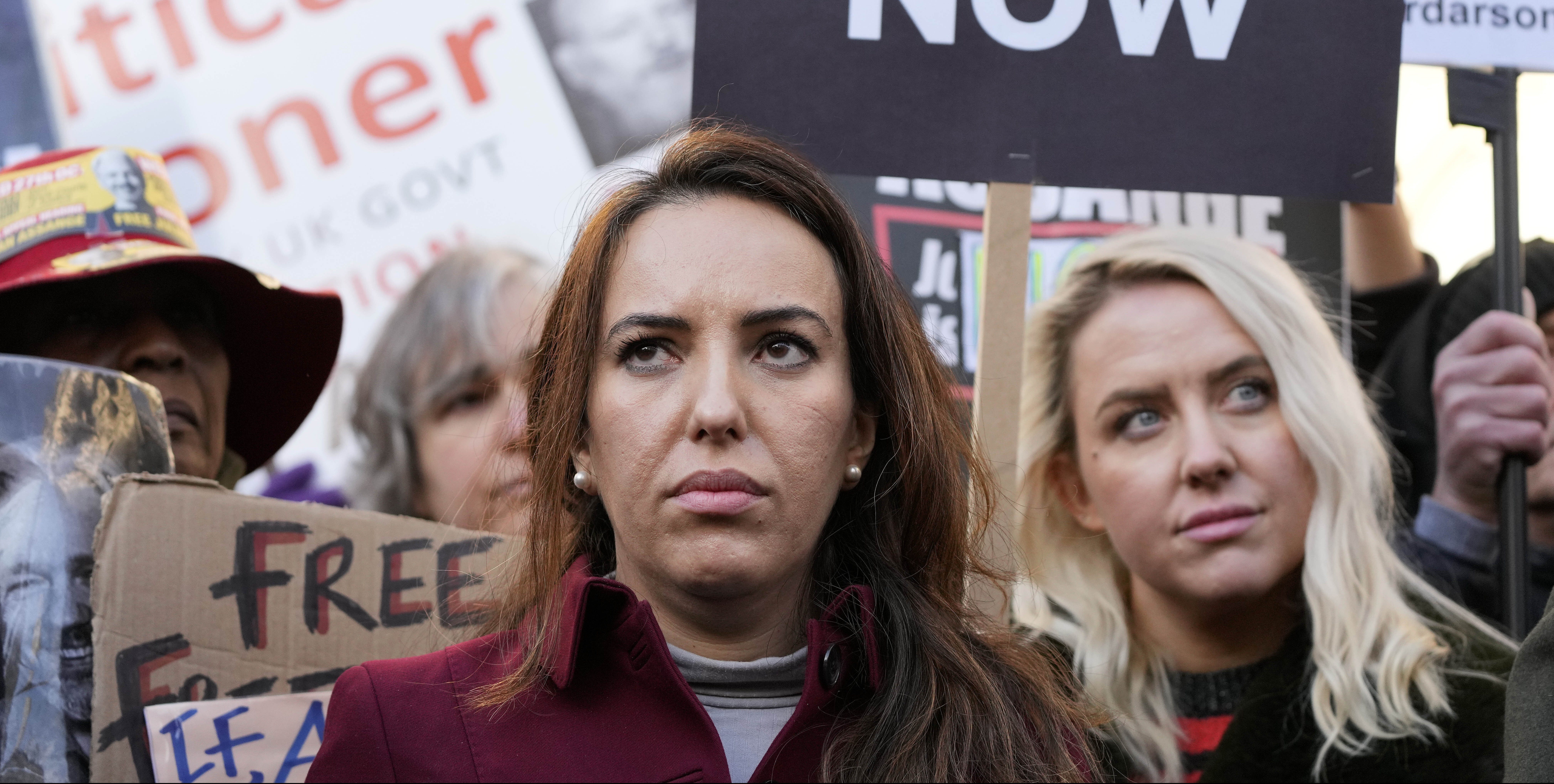 Stella Moris, partner of Julian Assange, stands with protestors in front of the High Court in London, Friday, Dec. 10, 2021. A British appellate court has opened the door for WikiLeaks founder Julian Assange to be extradited to the United States. The High Court overturned a lower court ruling that found Assange's mental health was too fragile to withstand the American criminal justice system. A lower court judge earlier this year refused an American request to extradite Assange to the U.S. to face spying charges over WikiLeaks' publication of secret military documents a decade ago. (AP Photo/Frank Augstein)