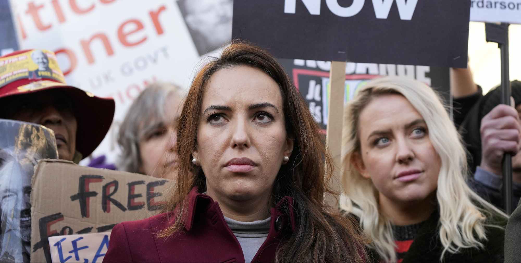 Stella Moris, partner of Julian Assange, stands with protestors in front of the High Court in London, Friday, Dec. 10, 2021. A British appellate court has opened the door for WikiLeaks founder Julian Assange to be extradited to the United States. The High Court overturned a lower court ruling that found Assange's mental health was too fragile to withstand the American criminal justice system. A lower court judge earlier this year refused an American request to extradite Assange to the U.S. to face spying charges over WikiLeaks' publication of secret military documents a decade ago. (AP Photo/Frank Augstein)