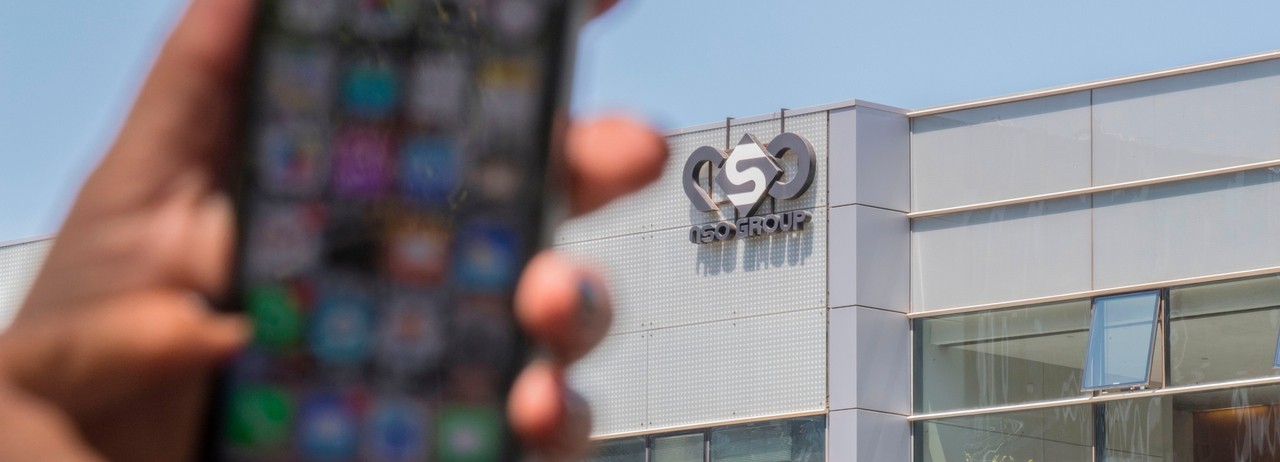 An Israeli woman uses her iPhone in front of the building housing the Israeli NSO group, on August 28, 2016, in Herzliya, near Tel Aviv.&nbsp;(Photo: Jack Guez/AFP via Getty Images)