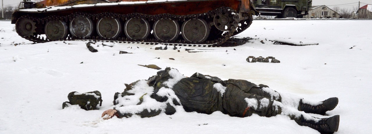 The body of a dead Russian soldier lies near destroyed military vehicles on the outskirts of Kharkiv, Ukraine on February 26, 2022.