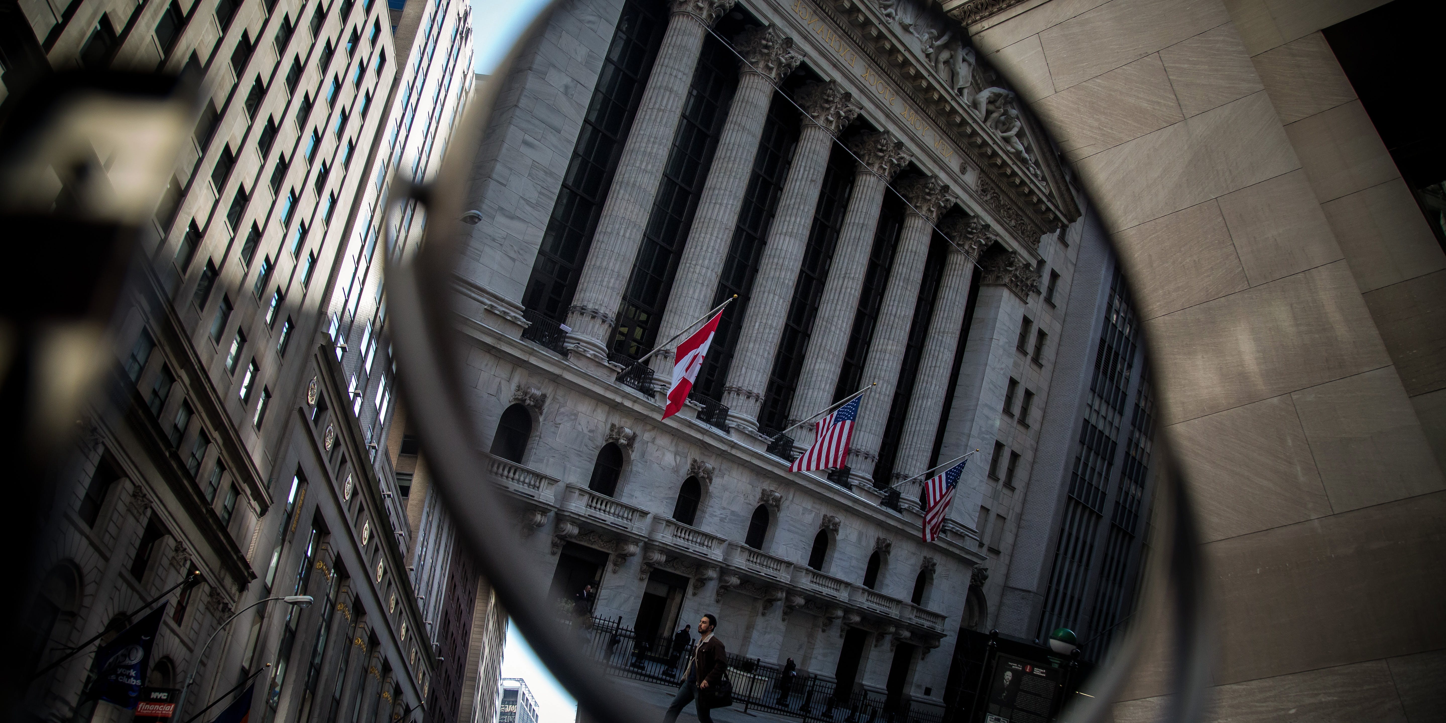 A pedestrian is reflected in a mirror while walking past the New York Stock Exchange (NYSE) in New York, U.S., on Monday, Feb. 22, 2016. U.S. stocks advanced, with the Standard &amp; Poor's 500 Index headed toward a six-week high, amid gains in banks and commodity shares as oil surged. Photographer: Michael Nagle/Bloomberg via Getty Images