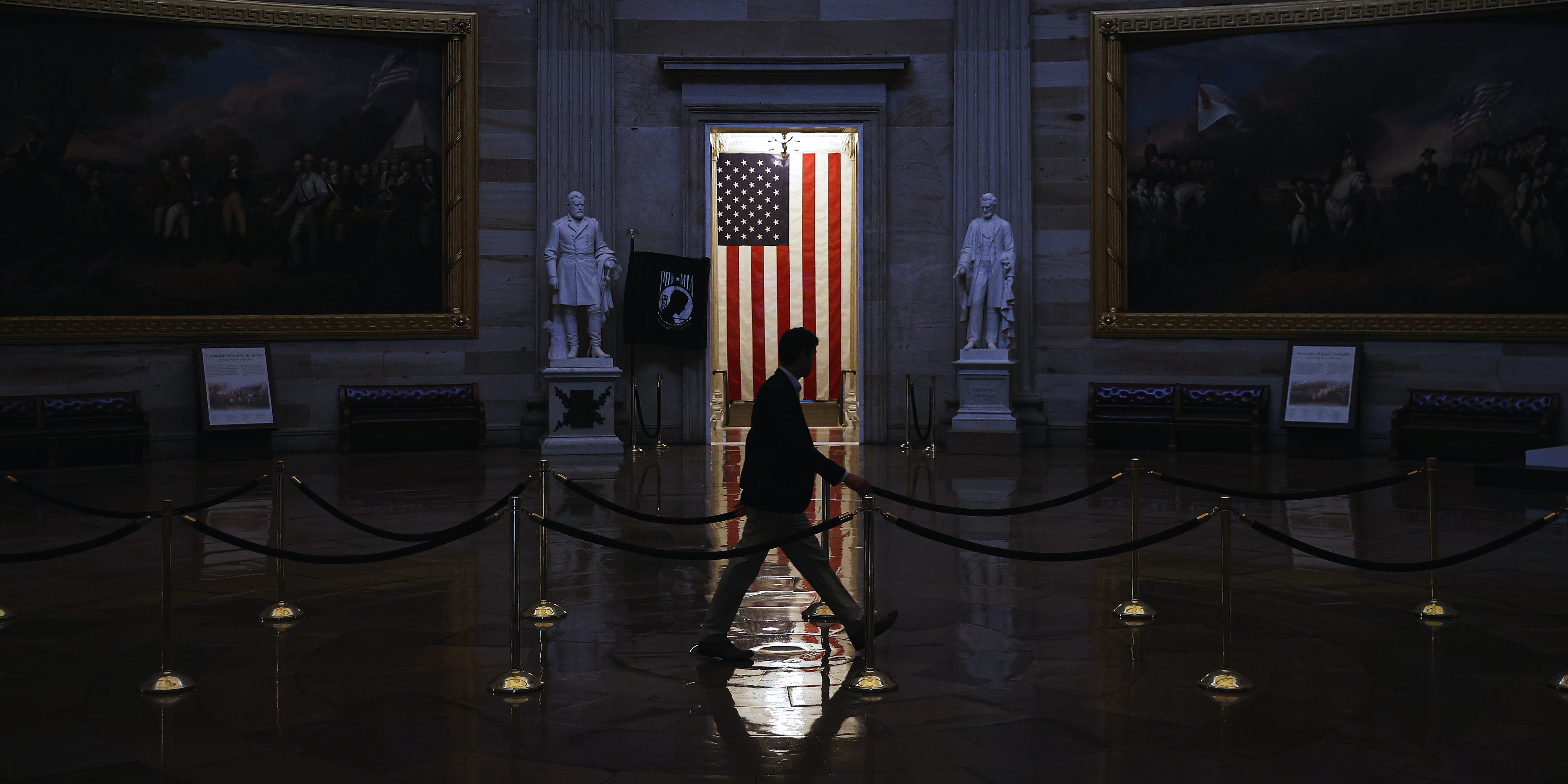 WASHINGTON, DC - MARCH 24:  A man walks through the U.S. Capitol Rotunda, empty of tourists as only essential staff and journalists are allowed to work during the coronavirus pandemic March 24, 2020 in Washington, DC. After days of tense negotiations -- and Democrats twice blocking the nearly $2 trillion package -- the Senate and Treasury Department appear to have reached important compromises on legislation to shore up the economy during the COVID-19 pandemic. (Photo by Chip Somodevilla/Getty Images)