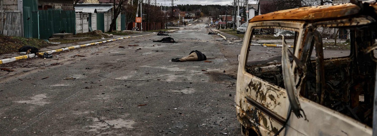 Bodies lie on a street in Bucha, northwest of Kyiv, on April 2, 2022, as Ukraine says Russian forces are making a "rapid retreat" from northern areas around Kyiv and the city of Chernigiv. 