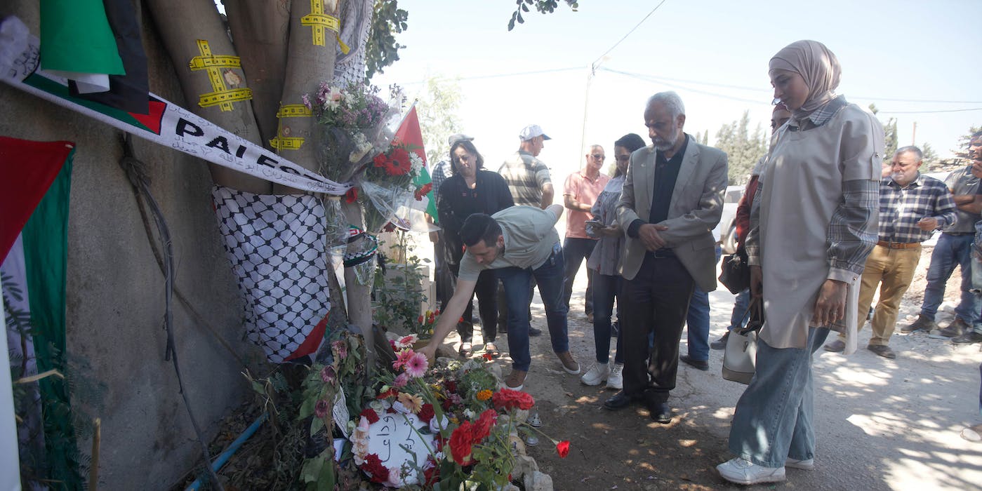 JENIN, WEST BANK, PALESTINE - 2022/05/18: Palestinians lay flowers at the site where Al-Jazeera correspondent Shireen Abu Akleh was killed in the city of Jenin in the occupied West Bank. Shireen Abu Akleh was shot dead by the Israeli army while covering the raid on the city. (Photo by Nasser Ishtayeh/SOPA Images/LightRocket via Getty Images)
