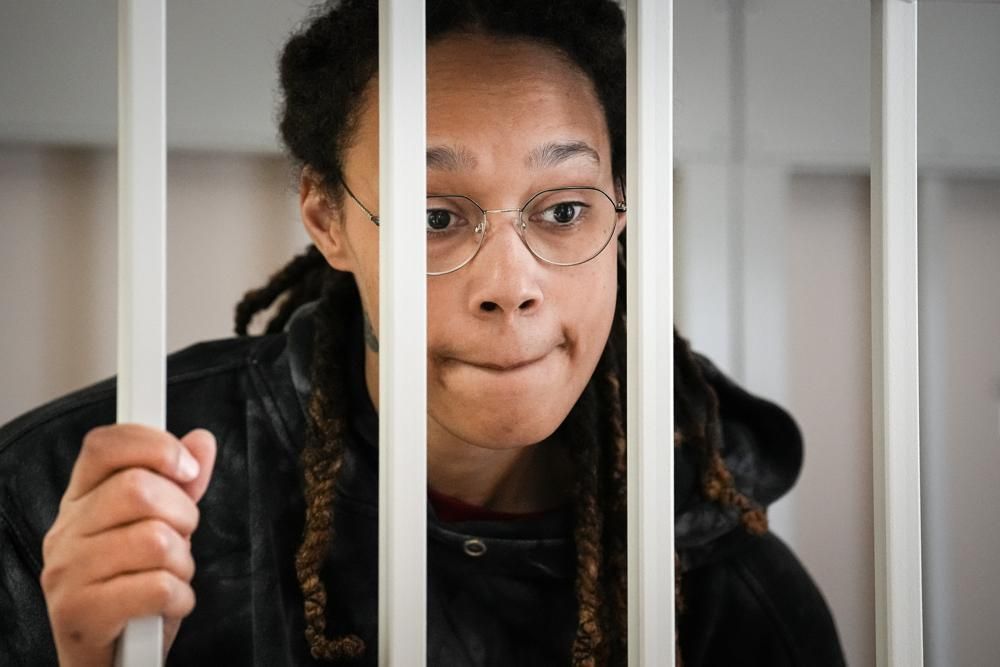 Griner speaks to her lawyers standing in a cage at a court room prior to a hearing, in Khimki just outside Moscow, Russia on July 26.