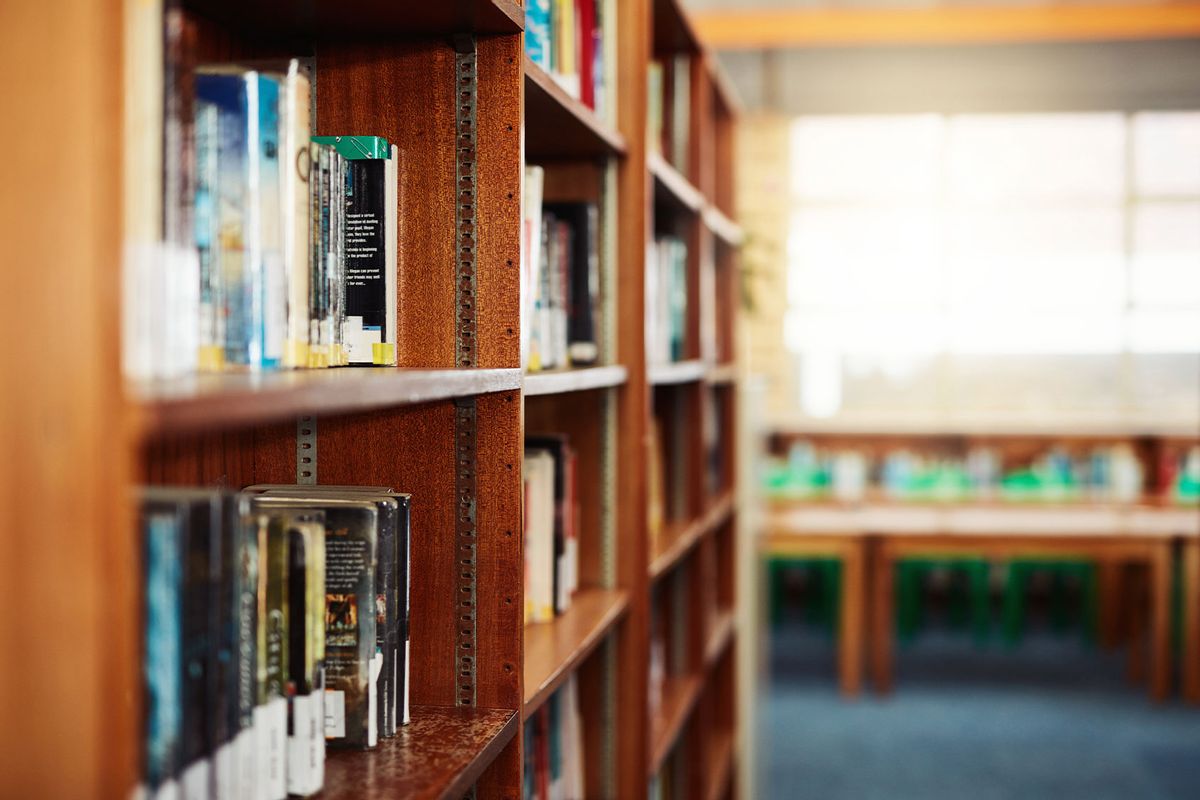 Shot of a shelf with books in an empty library (Getty Images/LumiNola)
