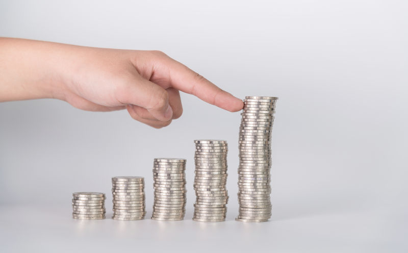 Finger-pushing-a-pile-of-coins, Image: iStock Finger pushing a pile of coins.