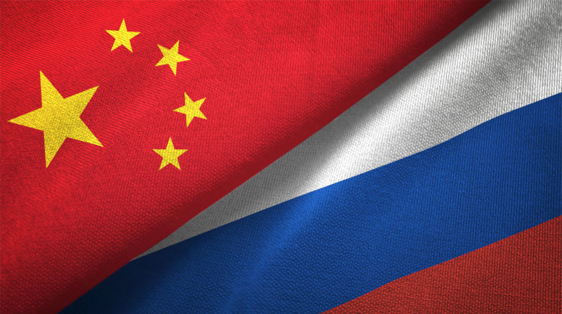 Russia and China flag together relations textile cloth fabric texture.