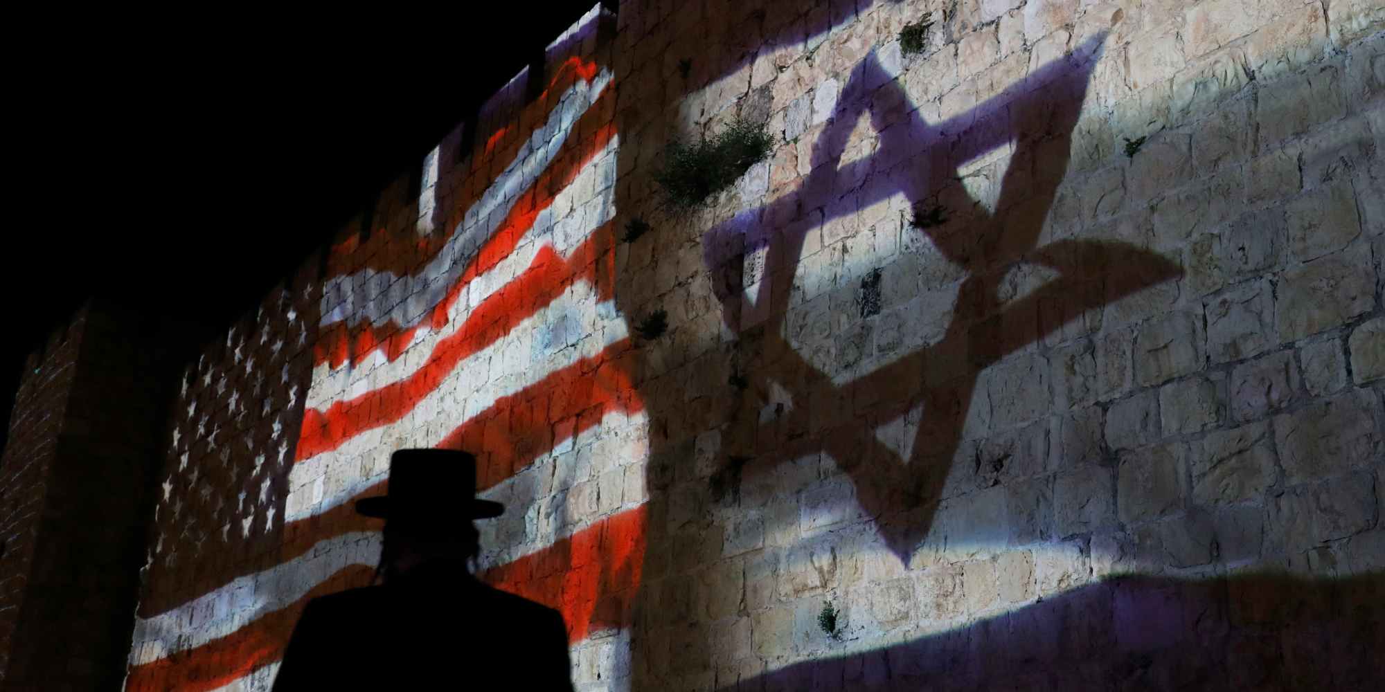 The Israeli and United States flags are projected on the walls of the ramparts of Jerusalem's Old City, to mark one year since the transfer of the US Embassy from Tel Aviv to Jerusalem on May 15, 2019.