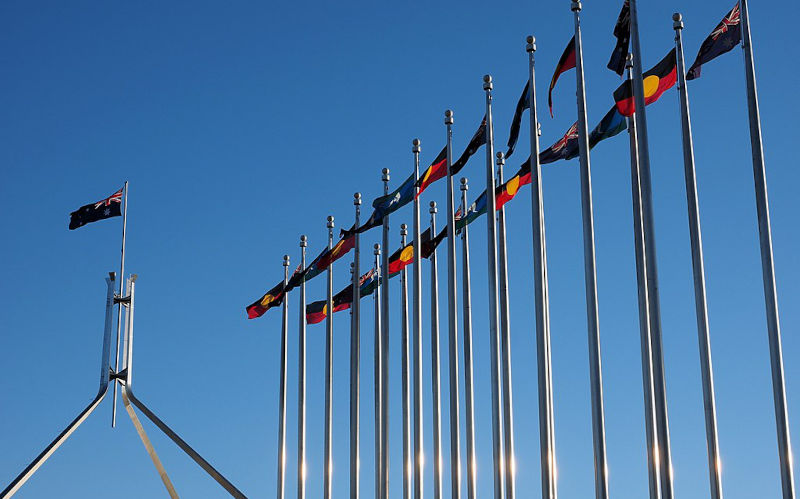 Torres Strait Islander and Australian flags outside the Australian Parliament House in July 2016.