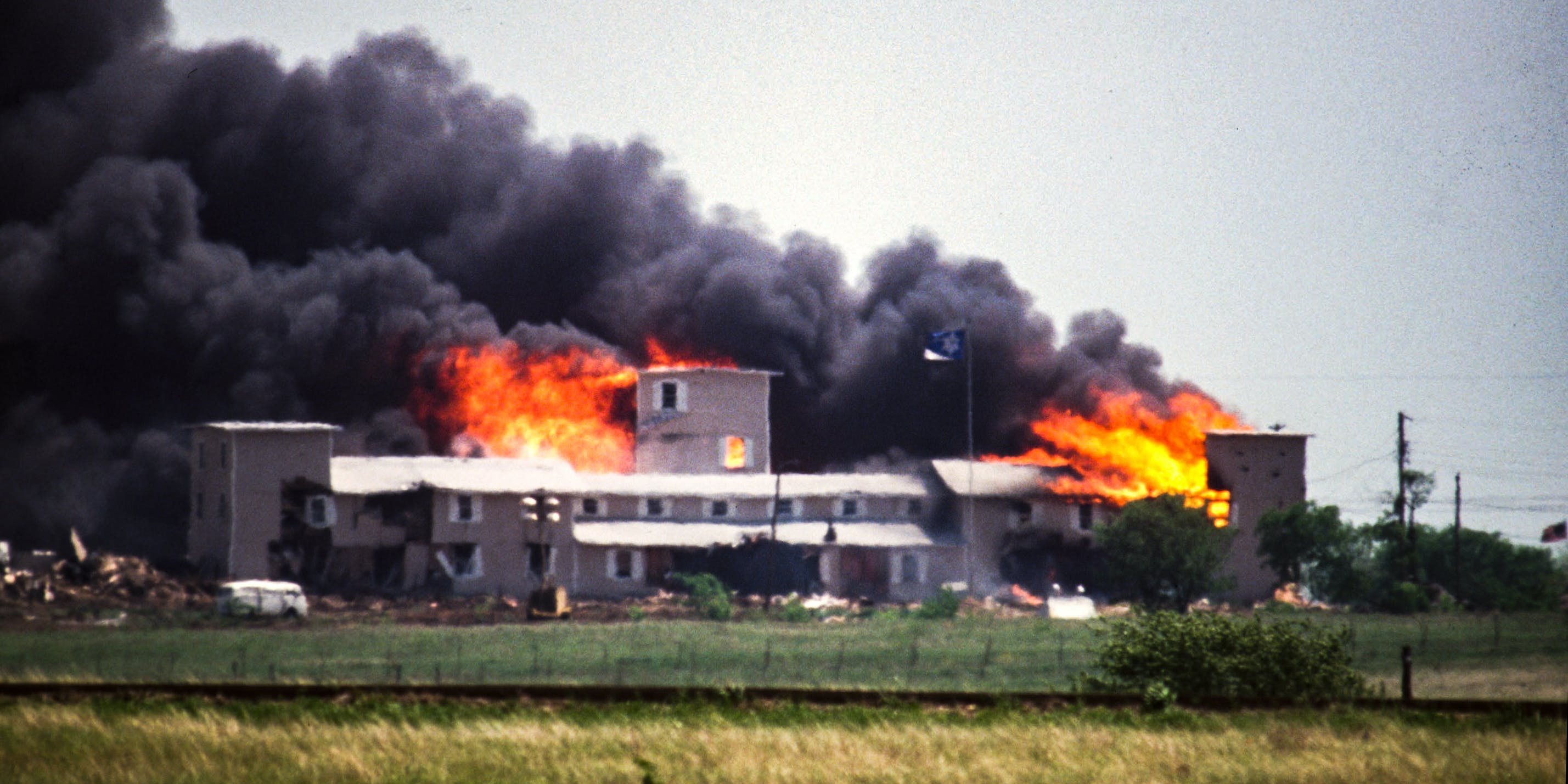 Smoking fire consumes the Branch Davidian Compound during the FBI assault to end the 51-day standoff with cult leader David Koresh and his followers. --- Photo by Greg Smith/Corbis SABA (Photo by Greg Smith/Corbis via Getty Images)