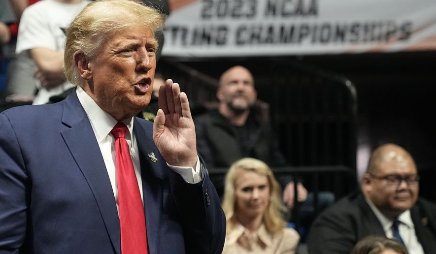 Former President Donald J. Trump watches the NCAA Wrestling Championships, Saturday, March 18, 2023, in Tulsa, Okla. (AP Photo/Sue Ogrocki)