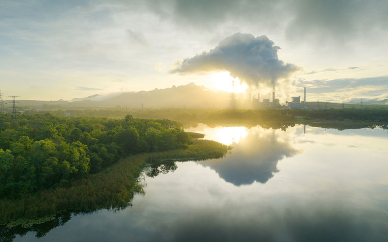 Aerial view coal power plant station in the morning mist, the morning sunrises. coal power plant and environment concept. Coal and steam. Mae Moh, Lampang, Thailand.