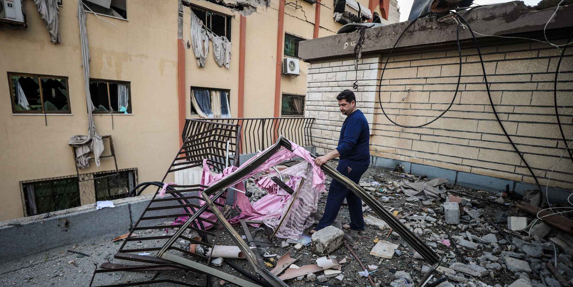 GAZA CITY, GAZA - MAY 09: A Palestinian man examines damaged buildings after the airstrikes carried out by the Israeli military, working with Israel's Shin Bet internal security service, in Gaza City, Gaza on May 09, 2023. Twelve people were killed, including women and children, and 20 others injured. (Photo by Ali Jadallah/Anadolu Agency via Getty Images)