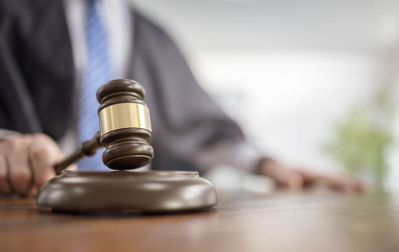 Judge-holding-gavel-in-court-room. Image: iStock Judge holding gavel in court courtroom at trial