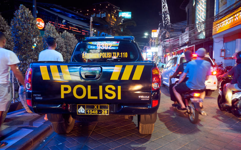 Police-car-on-the-road-in-Kuta,-Bali,-Indonesia. Image: iStock Kuta, Bali, Indonesia - Police car on the road in heavy traffic on the island at night