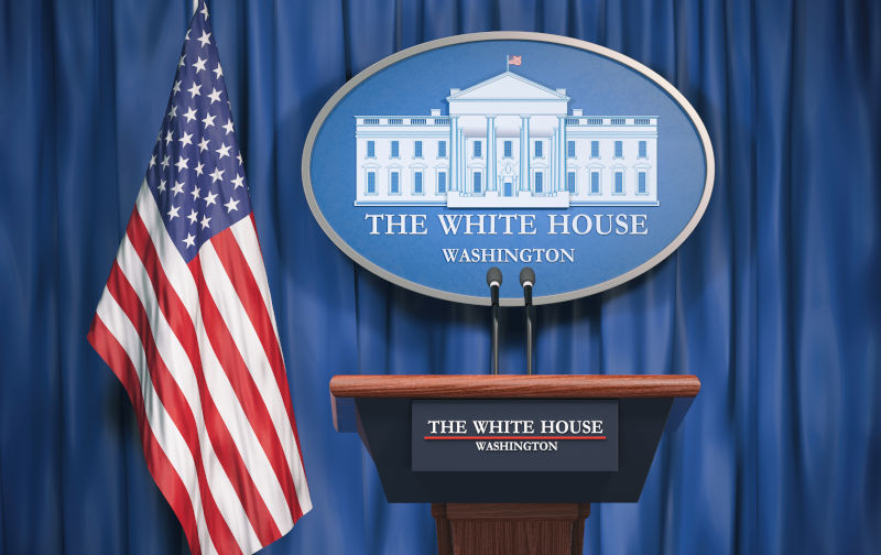 Politics of White House and President of USA United states concept. Podium speaker tribune with USA flags and sign of White House.