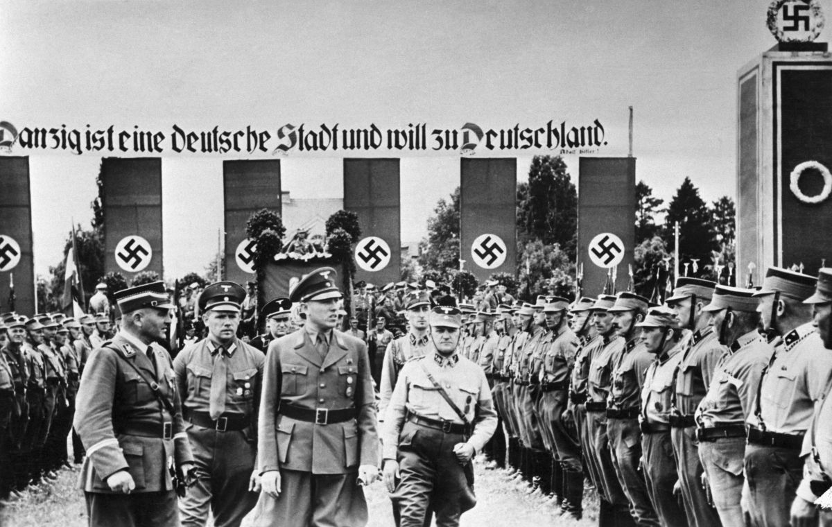 The Danzig district leader of the Nazi party, Albert Foerster reviews local Nazis standing in formation and wearing uniforms shortly before Hitler invaded Poland in 1939.​
