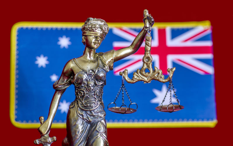 Statue of lady Justice and Australian flag.