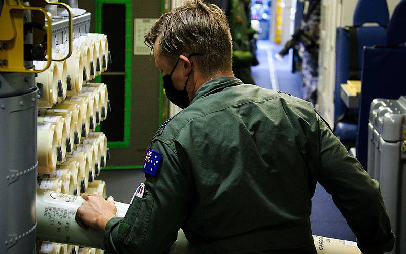 220720-N-OZ224-1008 JOINT BASE PEARL HARBOR-HICKAM, Hawaii (July 20, 2022) – Royal Australian Air Force Flight Lt. Nathan Owen loads sonobuoys on a P-8A Poseidon at Pearl Harbor during Rim of the Pacific (RIMPAC) 2022, July 20. Twenty-six nations, 38 ships, three submarines, more than 170 aircraft and 25,000 personnel are participating in RIMPAC from June 29 to Aug. 4 in and around the Hawaiian Islands and Southern California. The world's largest international maritime exercise, RIMPAC provides a unique training opportunity while fostering and sustaining cooperative relationships among participants critical to ensuring the safety of sea lanes and security on the world's oceans. RIMPAC 2022 is the 28th exercise in the series that began in 1971. Image: Wikimedia Commons/ U.S. Navy photo by Aviation Structural Mechanic Airman Apprentice Hannah Cox/ no copyright license