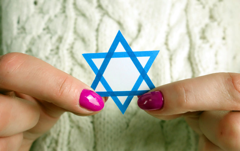 Unknown woman holding David Star. Israel, Judaism, Holocaust, Zionism concept.