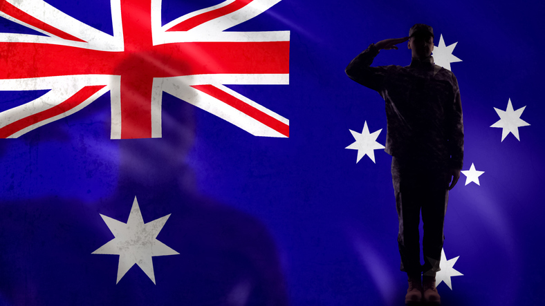 Australian soldier silhouette saluting against national flag, country protection. Image iStock