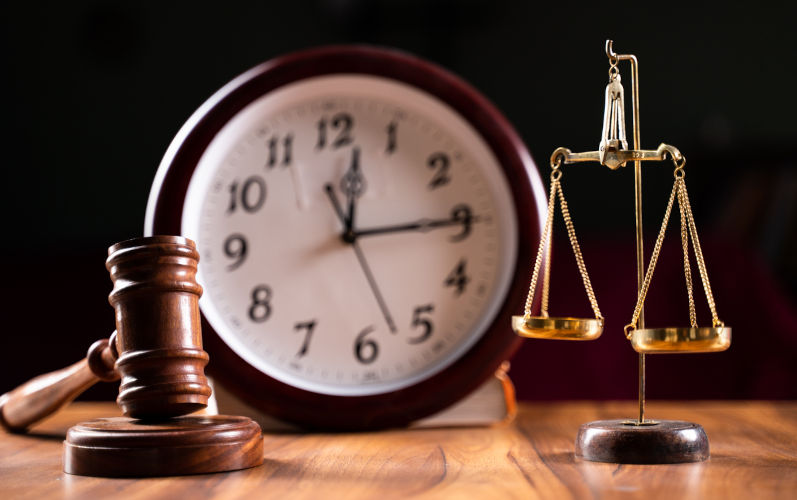 Concept showing of Problems with legal system, delay or slow in judicial justice system by using judge hammer, balance scale and wall clock