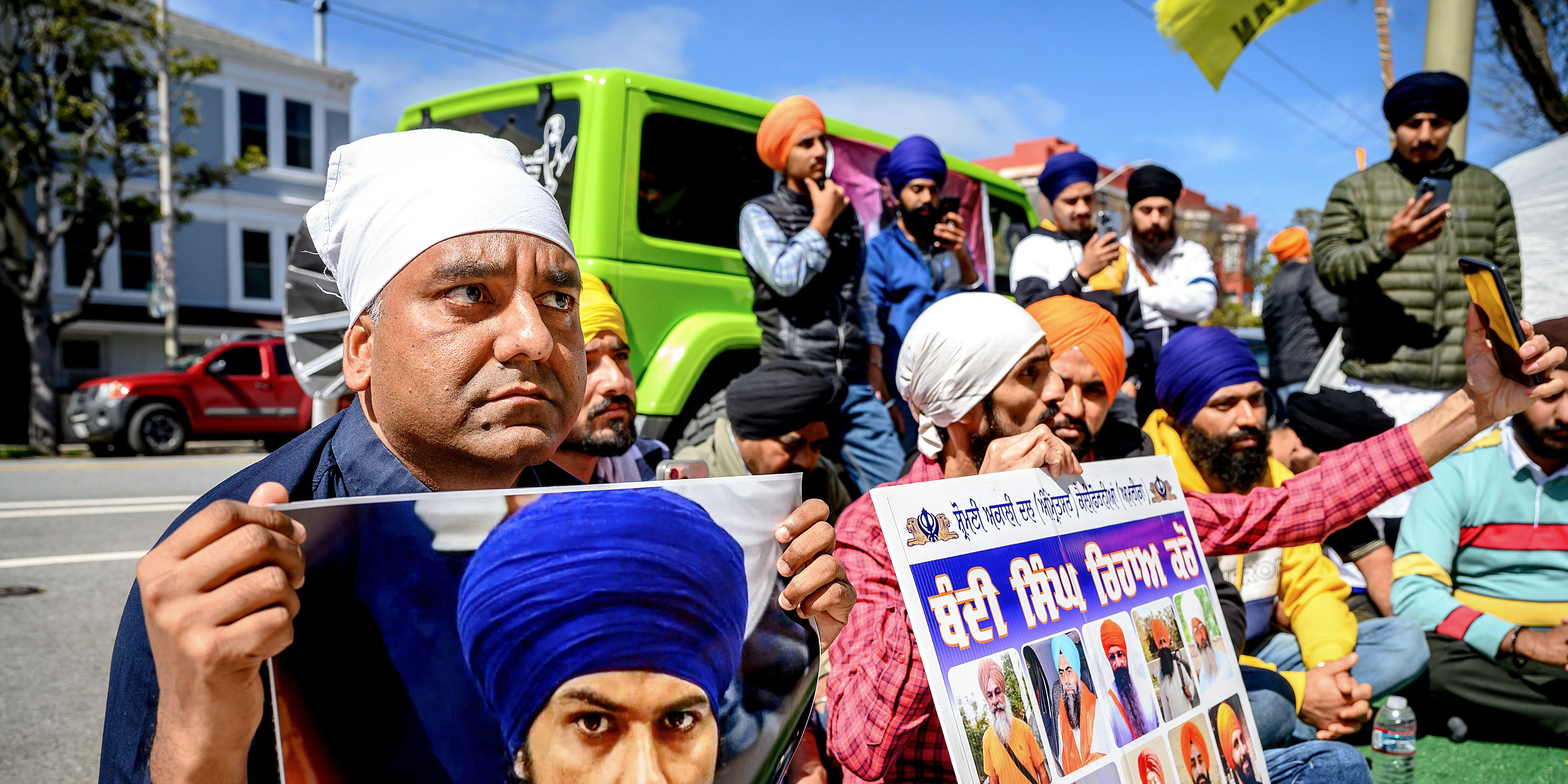 Raman Singh (L) holds a photo of Sikh organizer Amritpal Singh while protesting against the Indian government outside the Indian Consulate in San Francisco on March 20, 2023. - Indian authorities extended a mobile internet blackout across a state of about 30 million people on Monday as police hunted a radical Sikh preacher. The blackout extension came after supporters of Amritpal Singh were filmed vandalising India's consulate in San Francisco. A similar disturbance also took place in London. (Photo by NOAH BERGER / AFP) (Photo by NOAH BERGER/AFP via Getty Images)