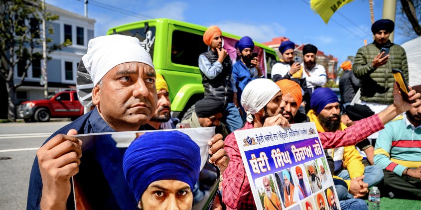 Raman Singh (L) holds a photo of Sikh organizer Amritpal Singh while protesting against the Indian government outside the Indian Consulate in San Francisco on March 20, 2023. - Indian authorities extended a mobile internet blackout across a state of about 30 million people on Monday as police hunted a radical Sikh preacher. The blackout extension came after supporters of Amritpal Singh were filmed vandalising India's consulate in San Francisco. A similar disturbance also took place in London. (Photo by NOAH BERGER / AFP) (Photo by NOAH BERGER/AFP via Getty Images)