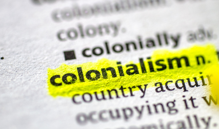 Close up photo of the word colonialism in a dictionary book. Image: iStock
