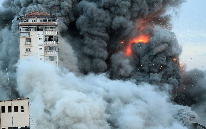 Smoke and flames billow after Israeli forces struck a high-rise tower in Gaza City, October 7, 2023.