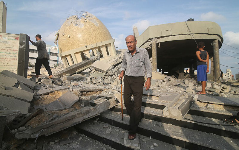Palestinians inspect the ruins of a building destroyed in Israeli airstrikes in Khan Younis in the southern of Gaza strip, on October 8, 2023. A mosque destroyed by an Israeli airstrike