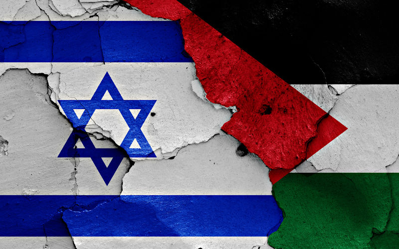 Israel and Palestine flags on cracked wall