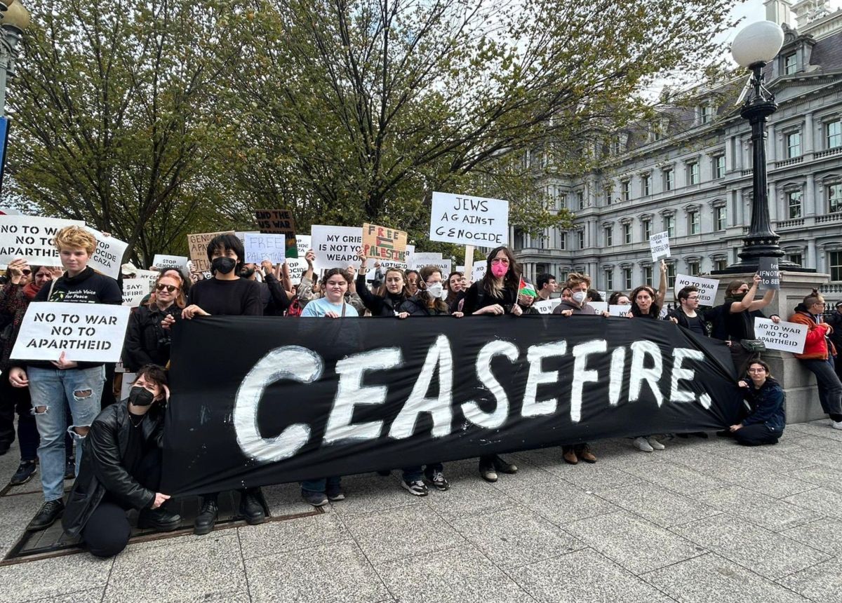Jewish-led peace activists hold a "ceasefire" banner outside the White House. 