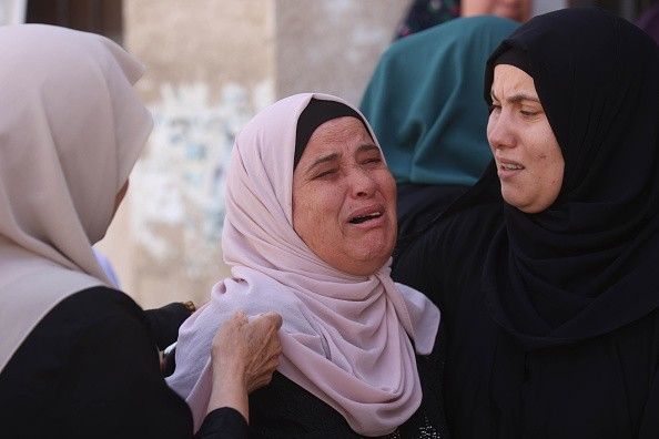 Relatives of Palestinians who lost their lives in an Israeli attack on Jenin refugee camp mourn