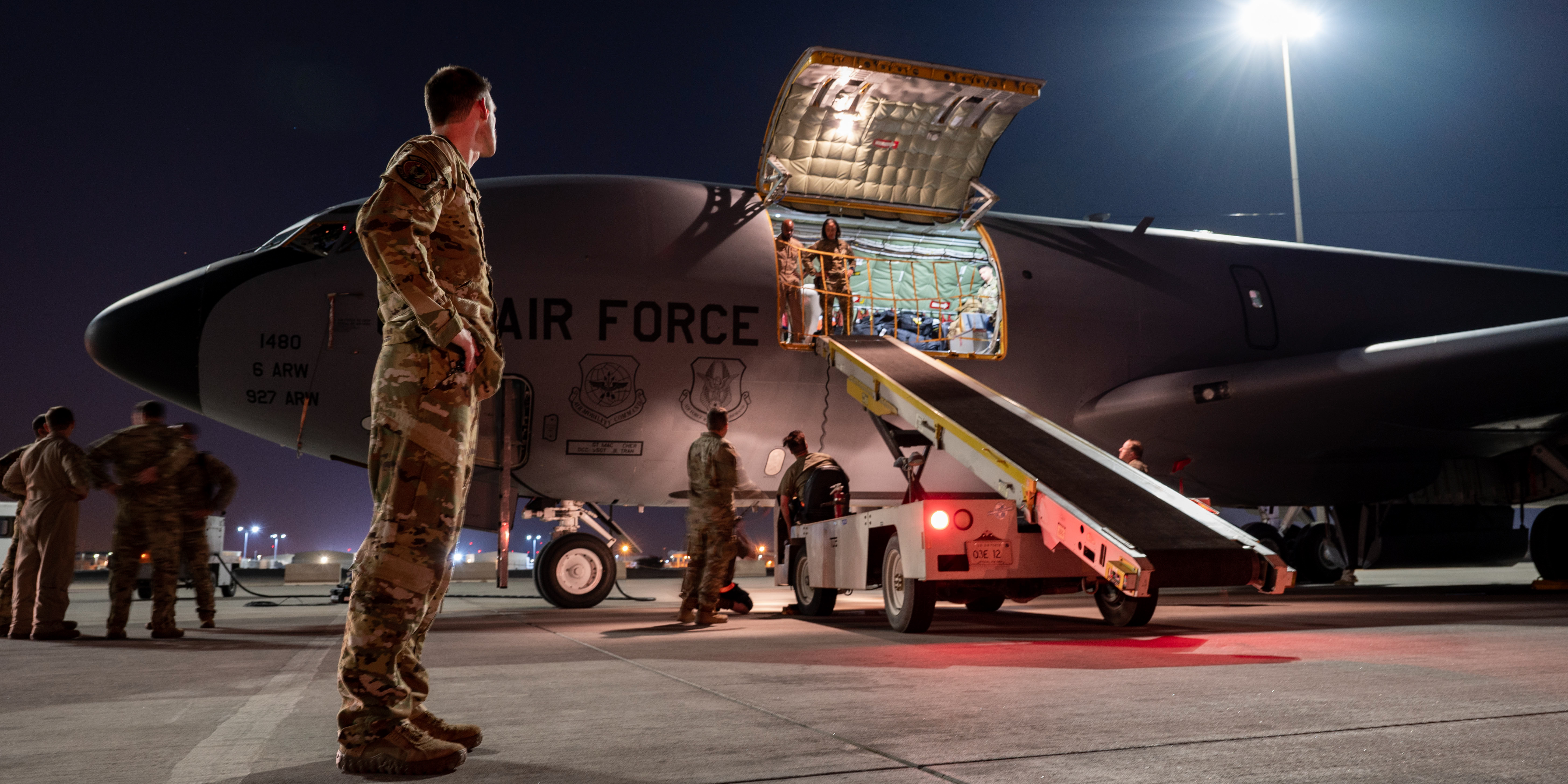 U.S. Air Force Lt. Col. Chris Knaute, a deployed Air Refueling Squadron commander, prepares to unload cargo from a KC-135 Stratotanker assigned to Fairchild Air Force Base, Wash., after its arrival at an undisclosed location within the U.S. Central Command area of responsibility, Oct. 23, 2023. The KC-135 provides aerial refueling support to U.S. and partner nations. The U.S. along with partner nations, operate a highly agile fighting force, leveraging the most advanced platforms to deter aggression and ensure stability in the region. These KC-135s were reassigned from MacDill AFB, Fla., to Fairchild, but the unit insignia has not been updated on the nose of the aircraft. (U.S. Air Force courtesy photo)