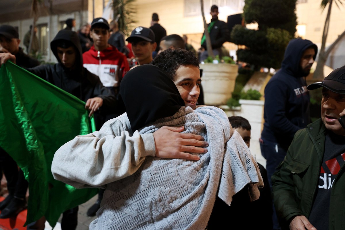 AL BIREH, WEST BANK - NOVEMBER 26: 39 Palestinians, brought by International Committee of the Red Cross vehicle, reunite with their relatives as they are released from Israeli Ofer prison as a part of Israel and Palestinian resistance group Hamas prisoner swap amid Humanitarian pause, according to Palestine Liberation Organization's prisoners in Al Bireh city of Ramallah, West Bank on November 26, 2023. Israeli authorities released 39 Palestinians, including 6 females, 33 minors as part of second batch of prisoner swap according to official Palestinian news agency WAFA. (Photo by Issam Rimawi/Anadolu via Getty Images)