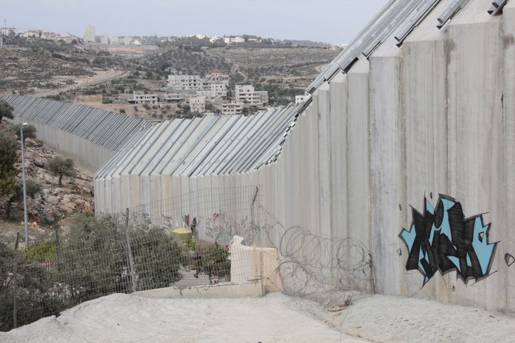 Wall Separating Palestine (West Bank) and Israel Image: iStock Graffiti on tall concrete wall that physically separates Palestinian territory (West Bank) and Israel - Bethlehem, Palestine Image: iStock