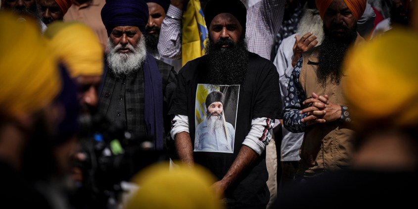 A mourner wears a t-shirt bearing a photograph of Sikh community leader and temple president Hardeep Singh Nijjar before Antim Darshan, the first part of day-long funeral services for him, in Surrey, British Columbia, Sunday, June 25, 2023. Nijjar was gunned down in his vehicle while leaving the Guru Nanak Sikh Gurdwara Sahib parking lot last week. (Darryl Dyck/The Canadian Press via AP)