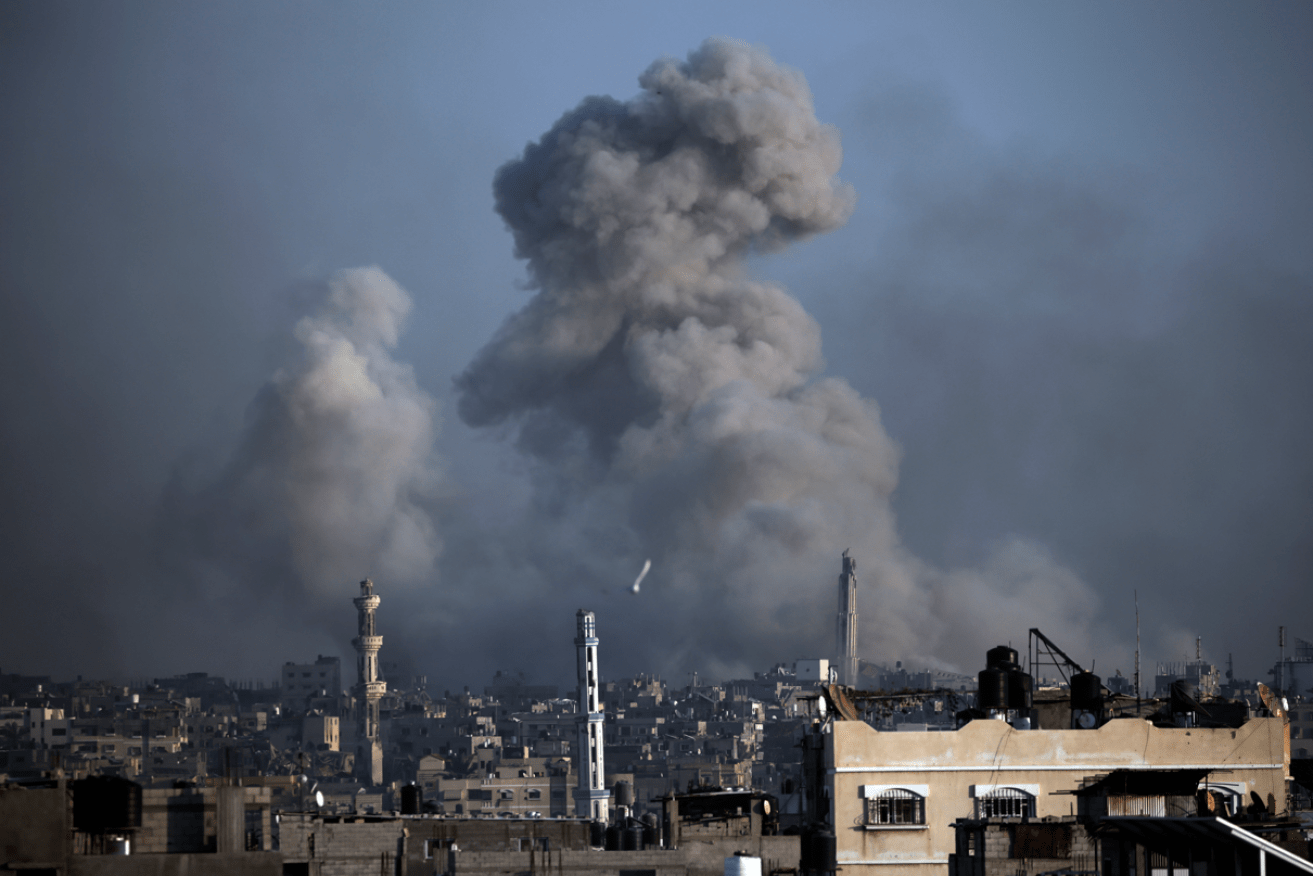 A column black smoke billows into the sky after another Israeli strike on Khan Younic in Gaza.