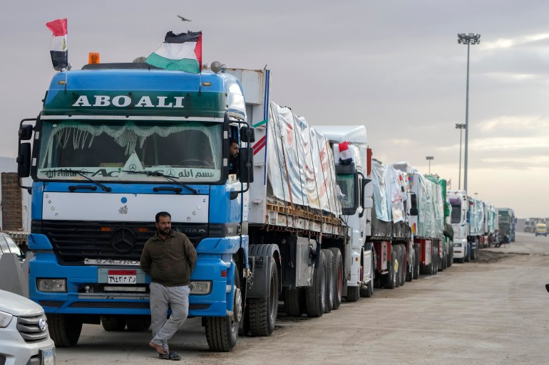 Trucks carrying humanitarian aid line up at the Rafah Border Crossing, Egypt, on the way to Gaza