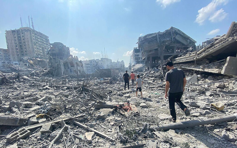 Palestinians inspect the damage following an Israeli airstrike on the El-Remal aera in Gaza City on October 9, 2023.