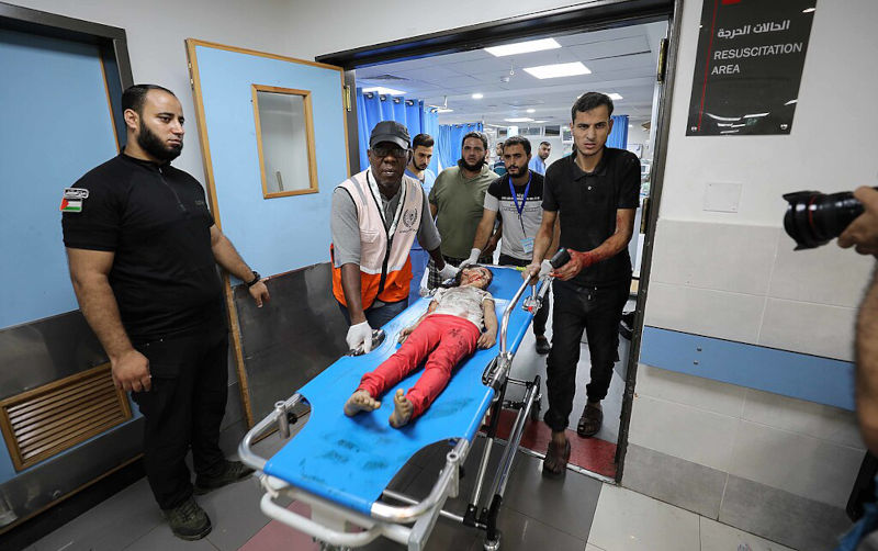 Wounded Palestinians wait for treatment at the overcrowded emergency ward of Al-Shifa hospital in Gaza City following an Israeli airstrike on October 11, 2023