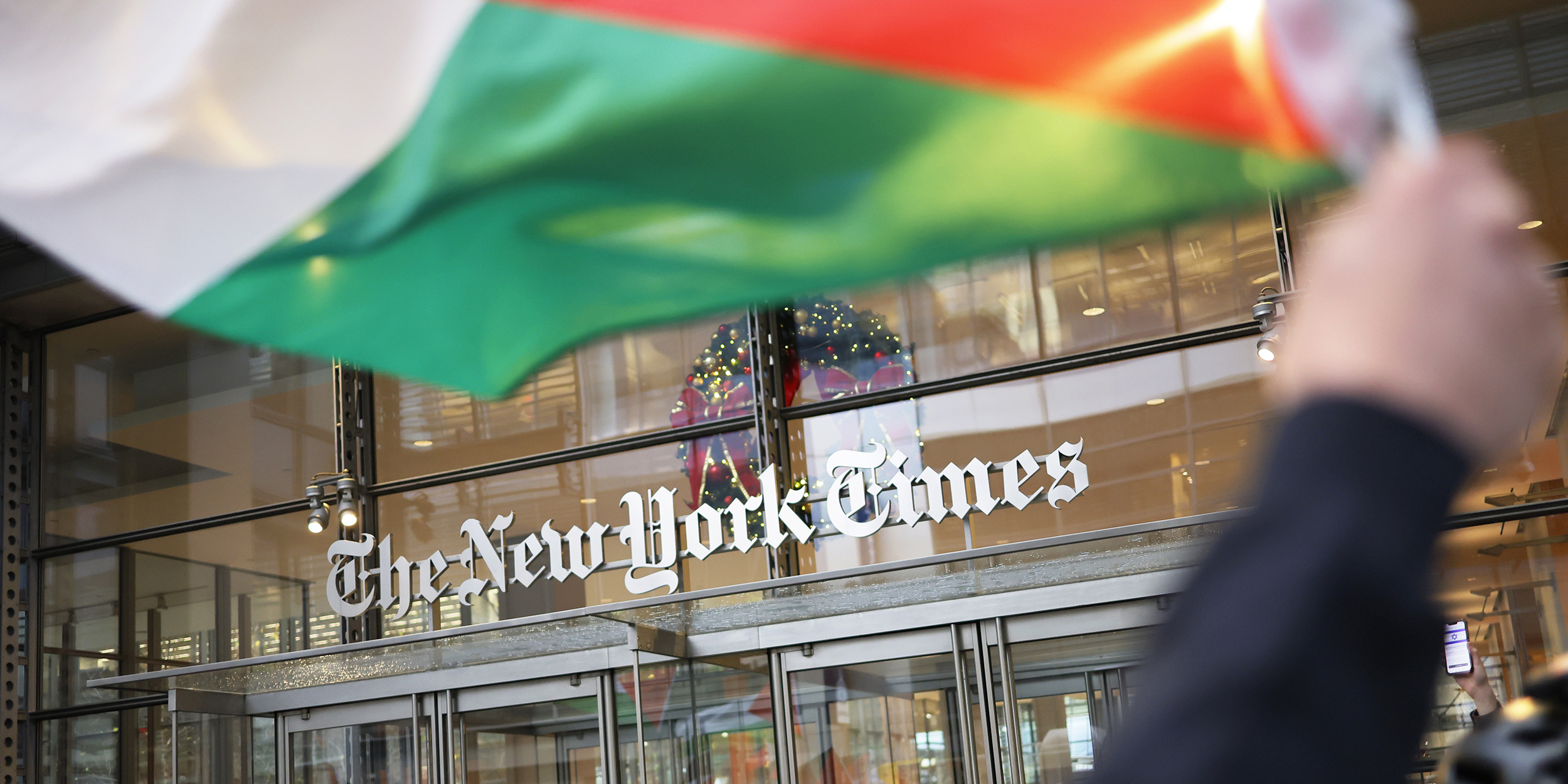 NEW YORK, NEW YORK - DECEMBER 18: NYPD officers guard the entrance to the New York Times as Pro-Palestine activists march as they participate in a Global Strike for Gaza on December 18, 2023 in New York City, New York. Activists gathered at Grand Central Station before marching as they continued to demand a ceasefire in Gaza. The protest convened just as the UN Security Council canceled an upcoming vote calling for a cessation of hostilities in Gaza as they try to change the language of the resolution to meet the US objections to the wording of the draft resolution saying they cannot support a “cessation of hostilities," but would agree to a call for a “suspension of hostilities." (Photo by Michael M. Santiago/Getty Images)