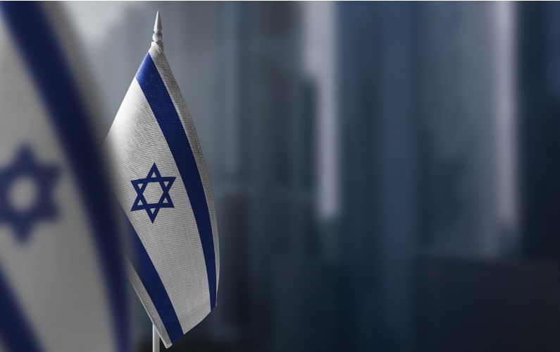 Small flags of Israel on a blurry background.