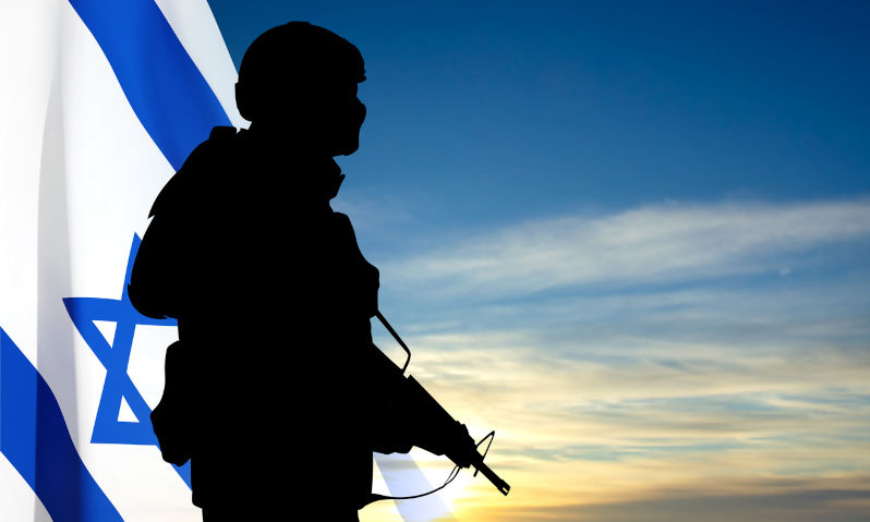 Silhouette of soldiers with Israel flag against the sunrise. Concept