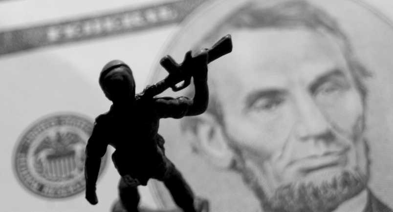 Toy soldiers on money showing USA President Lincoln's face.Image: iStock/keepphotos